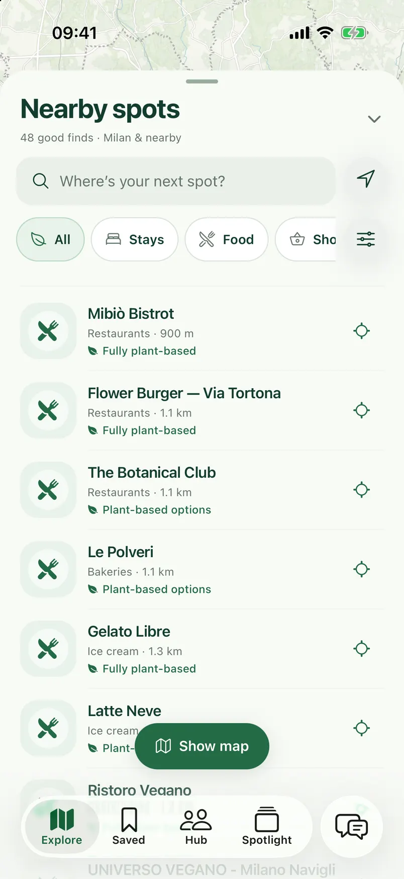 GreenSpotted Explore on iPhone: the Nearby spots list for Milan, with category filters and labels such as Fully plant-based and Plant-based options.